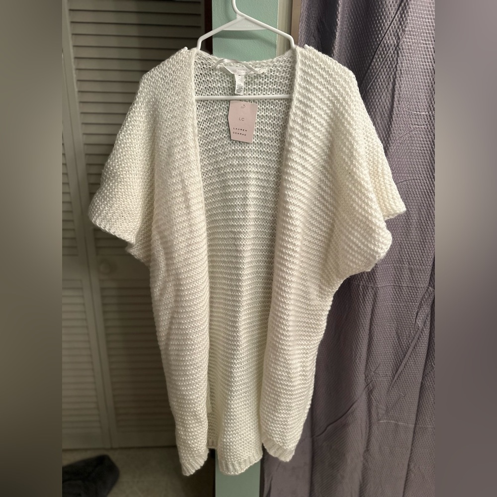 Poncho style vest. Never worn. Tag states one size fits all